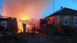Firefighters work at a house ablaze following a shelling that, according to the regional governor, was done by Ukrainian forces, in the village of Sobolevka, Belgorod region, Russia, in this handout image released June 2, 2023.