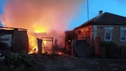 Firefighters work at a house ablaze following a shelling that, according to the regional governor, was done by Ukrainian forces, in the village of Sobolevka, Belgorod region, Russia, in this handout image released June 2, 2023.