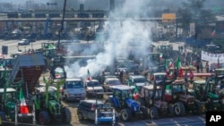 Farmers gather with their tractors near the highway junction, in Orte, Italy, Feb. 3, 2024. Farmers have been protesting in several parts of Italy and Europe against EU agriculture policies. 