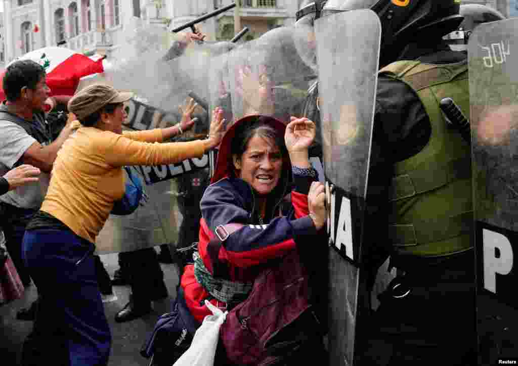 Anti-government demonstrators clash with police officers during a national protest to demand the resignation of Peruvian President Dina Boluarte, in Lima, Peru, July 29, 2023. 