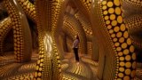 A visitor walks through a part of Japanese artist Yayoi Kusama's installation "You, Me and The Balloons" during a preview ahead of the start of the Manchester International Festival in Manchester, Britain, June 29, 2023. 