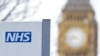 Logo dari Layanan Kesehatan Nasional Inggris (NHS) terlihat di Rumah Sakit St. Thomas Hospital, dengan latar belakang Menara Big Ben di London, pada 13 Januari 2017. (Foto: AFP/Isabel Infantes)