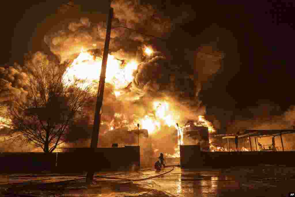 Firefighters extinguish a fire after a Russian attack on a residential neighborhood in Kharkiv, Ukraine, Feb. 10, 2024. 