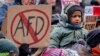 FILE - People protest against right-wing extremism in Frankfurt/Main, Germany, Jan. 20, 2024. Germany’s president has called for a broad “alliance against extremism” in the wake of a report about far-right discussions of deporting millions of immigrants.