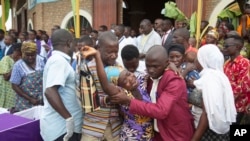 FILE—A relative reacts as people view the bodies of people killed following an attack by a rebel group based in the neighboring Democratic Republic of Congo on Friday, at the St François Xavier parish church, in Gatumba, Burundi, December 26, 2023.