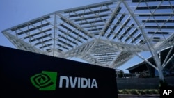 FILE - A Nvidia Corp. sign is shown in Santa Clara, Calif., May 31, 2023. AI chips and their leading designer, Nvidia, are now at the center of what some experts consider an AI revolution that could reshape the technology sector.