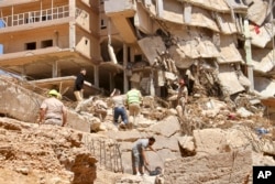 People search survivors in Derna, Libya, Sept.13, 2023.