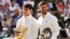 Carlos Alcaraz dari Spanyol (kiri) memegang trofi juara tunggal putra Wimbledon bersama Novak Djokovic dari Serbia usai final tunggal putra di kejuaraan tenis Wimbledon di London, Minggu 14 Juli 2024.