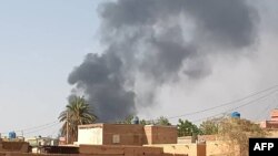 FILE- This picture taken in Aljazeera Eslang, north of Khartoum, shows smoke billowing in Omdurman, the capital's twin city, Sudan, July 3, 2023. 