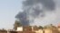 FILE- This picture taken in Aljazeera Eslang, north of Khartoum, shows smoke billowing in Omdurman, the capital's twin city, Sudan, July 3, 2023. 