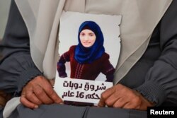 Sameera Dwayyat, the mother of Shorouq Dwayyat, 26, a female Palestinian prisoner serving a 16-year sentence, holds a picture of her daughter, amid the ongoing conflict between Israel and the Palestinian Islamist group Hamas, in Jerusalem, Nov. 22, 2023.