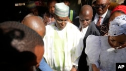 FILE - Atiku Abubakar, leader of the Peoples Democratic Party, center, attends elections in Yola, Nigeria, Feb. 25, 2023. The party said July 25, 2023, that it believes attackers were plotting to kill Abubakar.