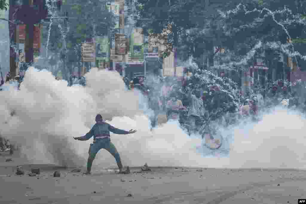 A teargas canister detonates as a protester gestures at Kenyan anti-riot police officers during anti-government protests in Nairobi.&nbsp;Police were out in force in the center of Kenya&#39;s capital after calls for more demonstrations against the embattled government of President William Ruto.