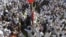 FILE - Thousands take part in a mass funeral procession for 27 people killed in a suicide bombing, at the Grand Mosque in Kuwait City, Kuwait, on June 27, 2015.