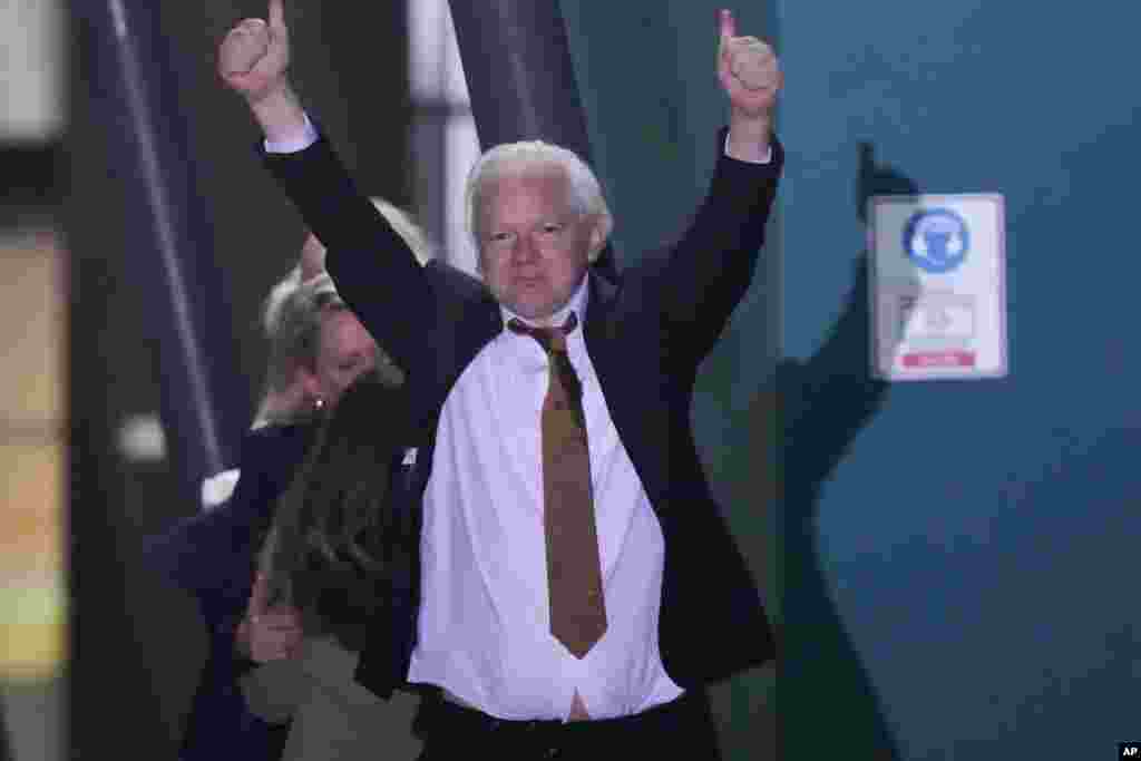 WikiLeaks founder Julian Assange gestures after landing at RAAF air base Fairbairn in Canberra, Australia.&nbsp;Assange has returned to his homeland Australia aboard a charter jet hours after pleading guilty to obtaining and publishing U.S. military secrets in a deal with Justice Department prosecutors that concludes a drawn-out legal saga.