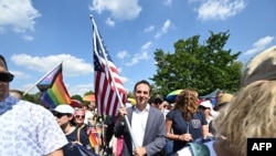 US Ambassador to Hungary David Pressman (C) holds the US flag during the LGBTQ+ Pride Parade in Budapest, Hungary, on July 15, 2023