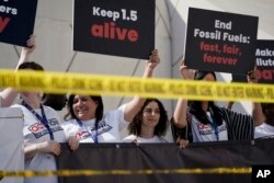 FILE - Activists protest against fossil fuels at the COP28 U.N. Climate Summit, Dec. 5, 2023, in Dubai, United Arab Emirates. The European climate agency said Feb. 8, 2024, that Earth has broken heat records each month since June 2023.