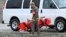 A U.S. Marine carries gear at a command center in Kitchen Creek, Calififornia, Feb. 7, 2024. A Marine Corps helicopter that had been missing with five troops aboard was found Wednesday morning in a mountainous area outside San Diego.