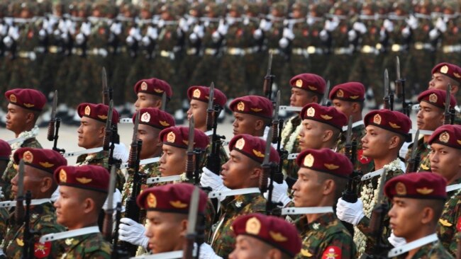 FILE - Military officers march during a parade in Naypyitaw, Myanmar, March 27, 2023. The country's military government revealed last week how it will implement its newly activated conscription law.