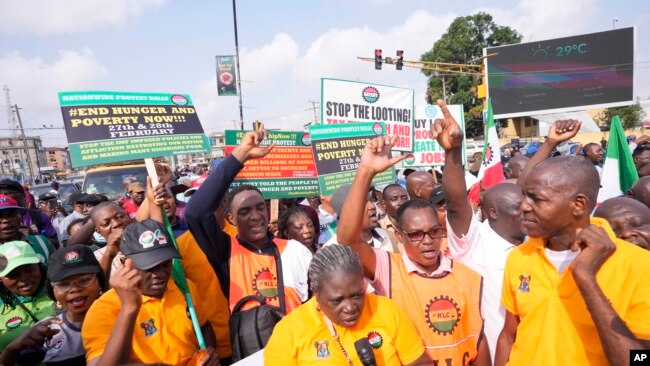 Labor union members march to protest economic hardship, in Lagos, Nigeria, Feb. 27, 2024. Nigerian workers began a new nationwide strike that threatens to shut down key services across the country.