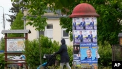 Campaign posters promote candidates as Poles vote in local and regional elections in Lomianki, near Warsaw, April 21, 2024. 
