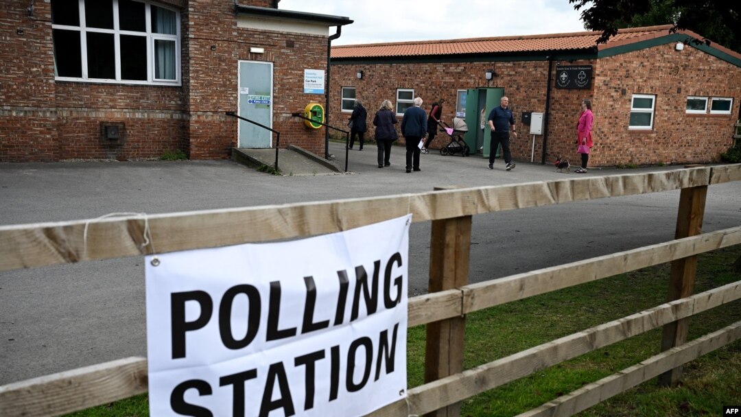 Voters arrive to a polling station at the Scout & Guide headquarters in Sowerby, north of England, July 4, 2024 as Britain holds a general election. Polls are predicting that Labour will win its first general election since 2005.