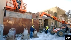 Workers begin demolition Wednesday, Jan. 17, 2023, at the Tree of Life building in Pittsburgh, the site of the deadliest antisemitic attack in U.S. history. (AP Photo/Gene J. Puskar, File)
