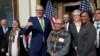 Washington Gov. Jay Inslee, third left, stands with Gerry Lewis of the Yakama Nation, fourth left, after a ceremony in Washington, Feb. 23, 2024. The Biden administration, four tribes and two governors launched a plan to help Pacific Northwest salmon.