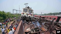 FILE - Rescuers work at the site of passenger trains that derailed in Balasore district, in the eastern Indian state of Orissa, June 3, 2023. 