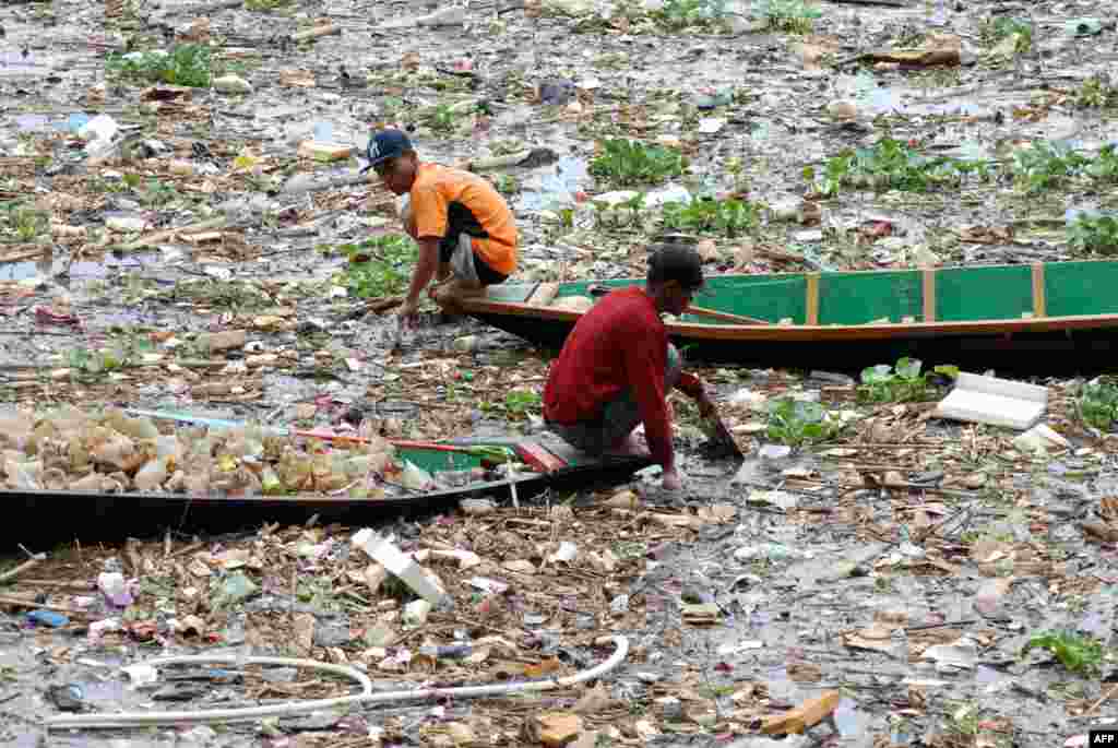 Two scavengers collect plastics in the Citarum river in Bandung, West Java, Indonesia.