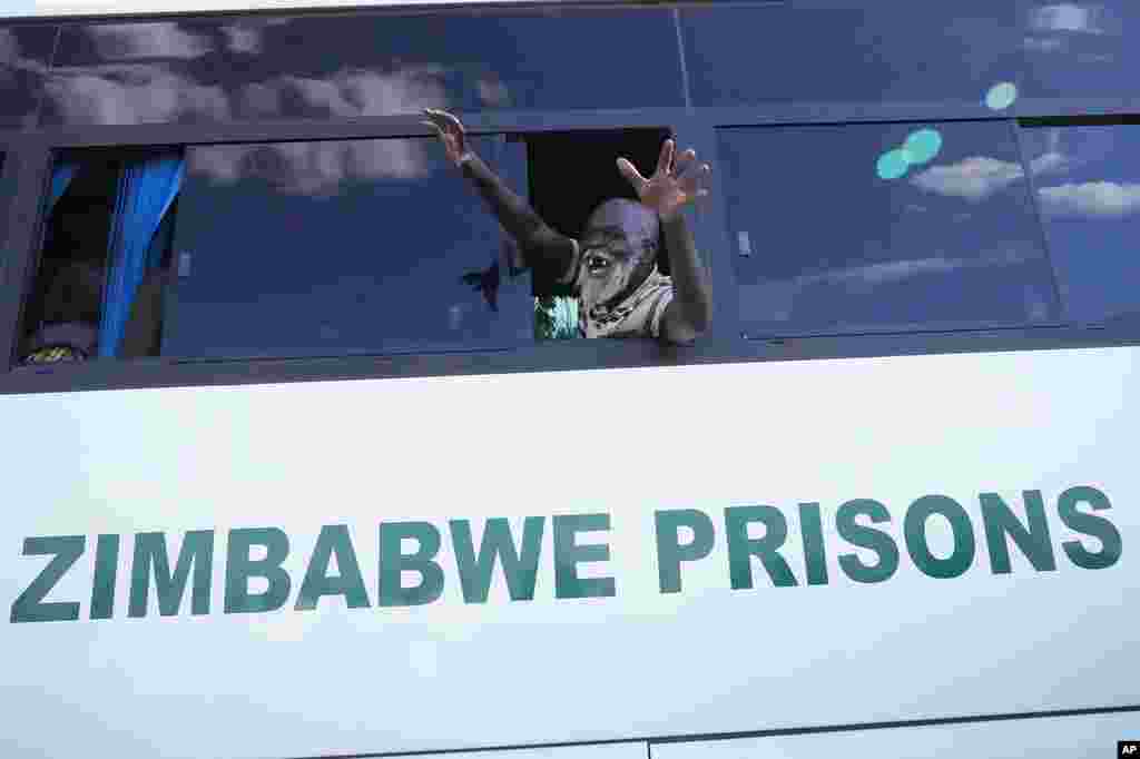 An elderly freed prisoner celebrates after he was released from Harare Central Prison in Harare, Friday, May, 19, 2023. Zimbabwe has begun releasing more than 4,000 prisoners under a presidential amnesty that authorities say will help ease congestion in some overcrowded jails.