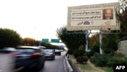 Traffic flows past a billboard installed on a highway by the Iranian capital's municipality, in Tehran, Oct. 30, 2023.