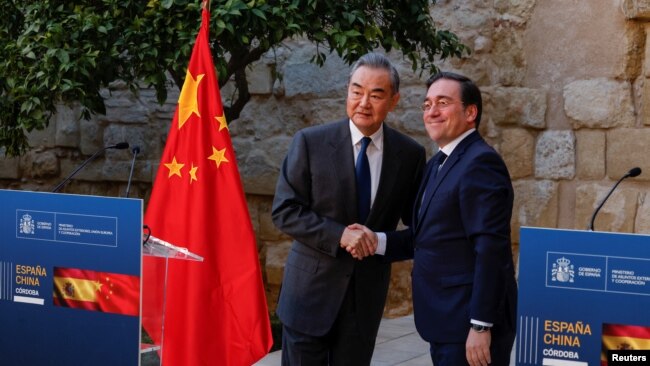 Spain's Foreign Minister Jose Manuel Albares, right, and China's Foreign Minister Wang Yi shake hands after a press conference following their meeting at Cordoba's Alcazar fortress, Spain, Feb. 18, 2024.