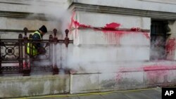 A worker cleans off the red paint thrown against the Foreign Office by pro-Palestinian protesters, in London, Nov. 7, 2023. Hundreds of thousands of protesters are expected to join a pro-Palestinian march in London on Nov. 11, 2023.