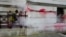 A worker cleans off the red paint thrown against the Foreign Office by pro-Palestinian protesters, in London, Nov. 7, 2023. Hundreds of thousands of protesters are expected to join a pro-Palestinian march in London on Nov. 11, 2023.