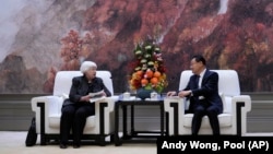 FILE - U.S. Treasury Secretary Janet Yellen, left, meets with Wang Weizhong, deputy party secretary and governor of Guangdong, center at the Baiyun International Conference Center in southern China's Guangdong province, April 5, 2024.