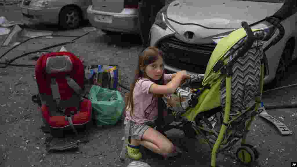 A 10-year-old girl looks after her 3-year-old sister at the site of Okhmatdyt children&#39;s hospital hit by Russian missiles, in Kyiv, July 8, 2024.