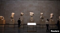 People view examples of the Parthenon sculptures, sometimes referred to in the UK as the Elgin Marbles, on display at the British Museum in London, Nov. 29, 2023.