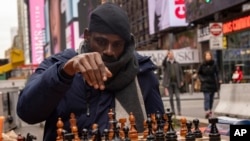 Tunde Onakoya, 29, a Nigerian chess champion and child education advocate, plays a chess game in Times Square, Friday, April 19, 2024 in New York.