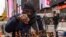 Tunde Onakoya, 29, a Nigerian chess champion and child education advocate, plays a chess game in Times Square, Friday, April 19, 2024 in New York.