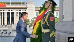 In this photo released by Xinhua News Agency, Cambodian Prime Minister Hun Manet lays a wreath at the Monument to the People's Heroes on the Tiananmen Square in Beijing on Thursday, Sept. 14, 2023. (Yue Yuewei/Xinhua via AP)