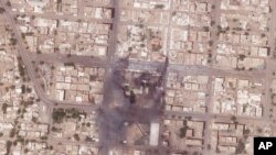 This satellite photo from Planet Labs PBC shows fires and destroyed market stalls in a commercial area of northern Khartoum, Sudan, April 18, 2023.