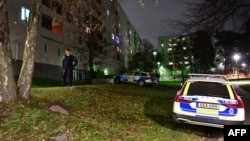 FILE - Police vehicles are parked outside an apartment block in Stockholm, Sweden, Nov. 14, 2021. An unnamed Chinese journalist reportedly was arrested in Stockholm last October and expelled last week after she was deemed a national security threat.