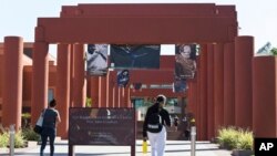 FILE - Students walk past the Harriet and Charles Luckman Fine Arts Complex at the California State University, Los Angeles, campus on April 25, 2019.