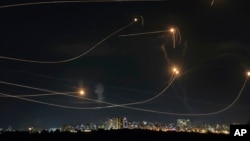 Israel's Iron Dome air defense system fires to intercept a rocket from the Gaza Strip, in Ashkelon, Oct. 20, 2023.