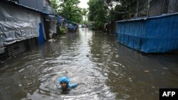 A boy swims through flood waters after heavy rain in Yangon, Myanmar.