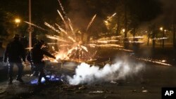 Police clear a street on the third night of protests sparked by the fatal police shooting of a 17-year-old driver in the Paris suburb of Nanterre, France, June 30, 2023.