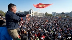 FILE - Large crowds gathered in Bishkek, Kyrgyzstan's capital, to protest the results of a parliamentary election, which gave the majority of seats to parties with ties to the ruling elites amid allegations of vote buying, Oct. 5, 2020.