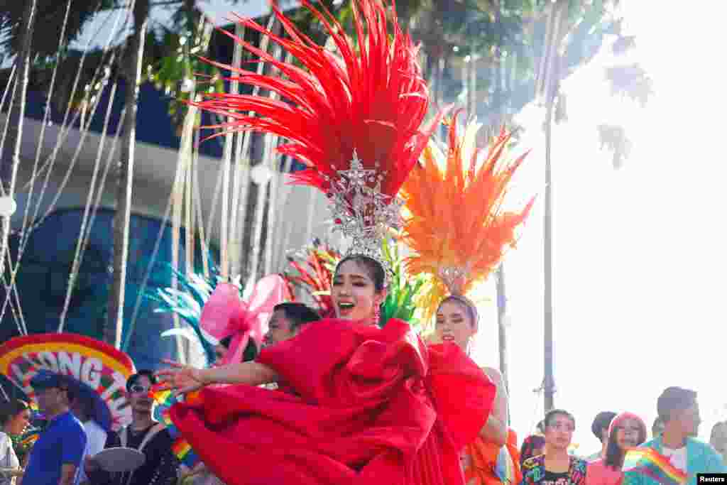 People take part in the annual LGBTQ+ Pride parade in Phuket, Thailand.