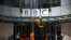 FILE - Repairmen work next to a sign at the British Broadcasting Corporation (BBC) headquarters in London, March 13, 2023. 